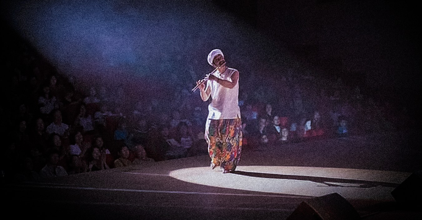 Rahul Ananda performing flute on stage